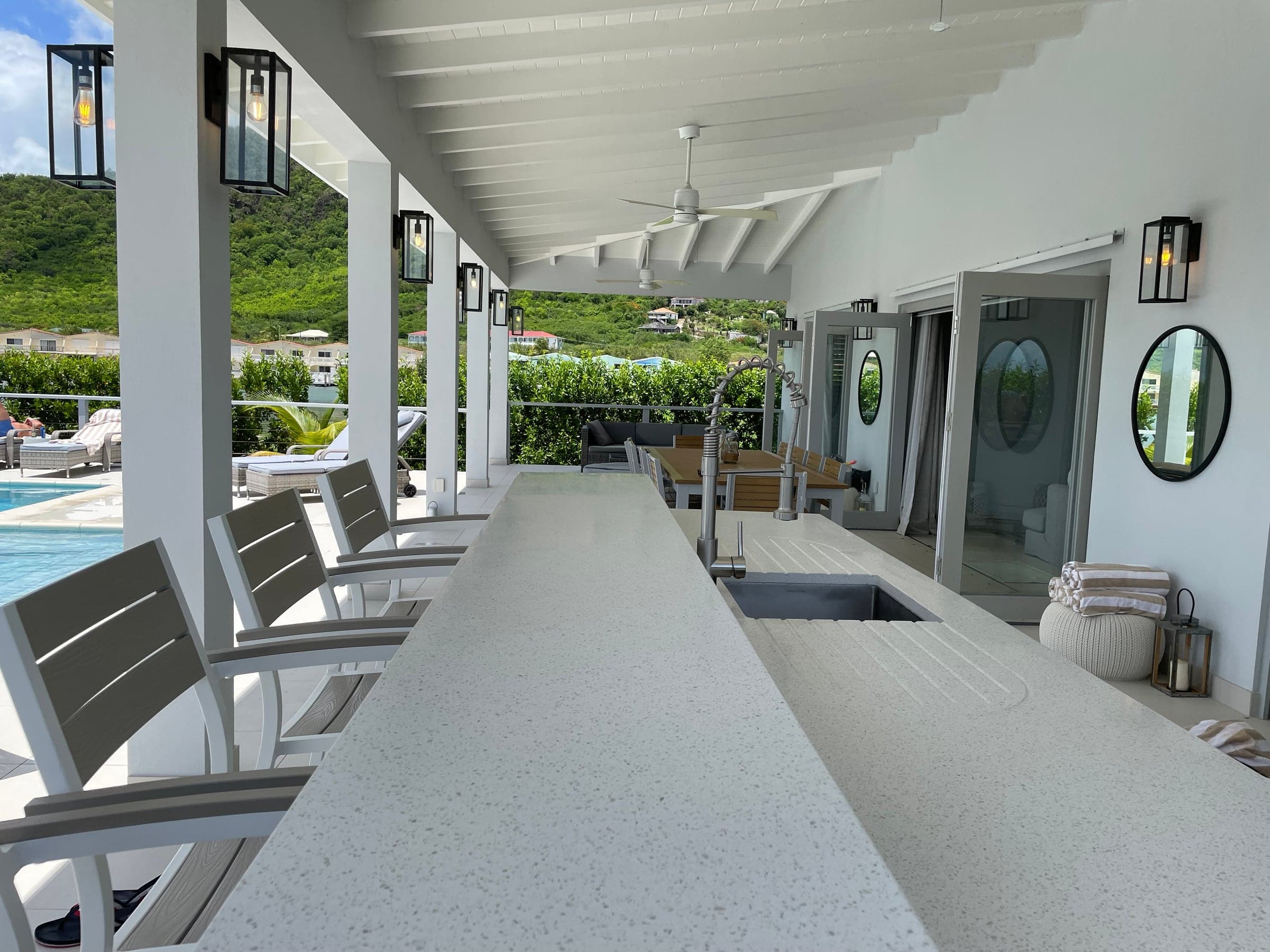 Outdoor kitchen and bar for relaxed poolside entertaining