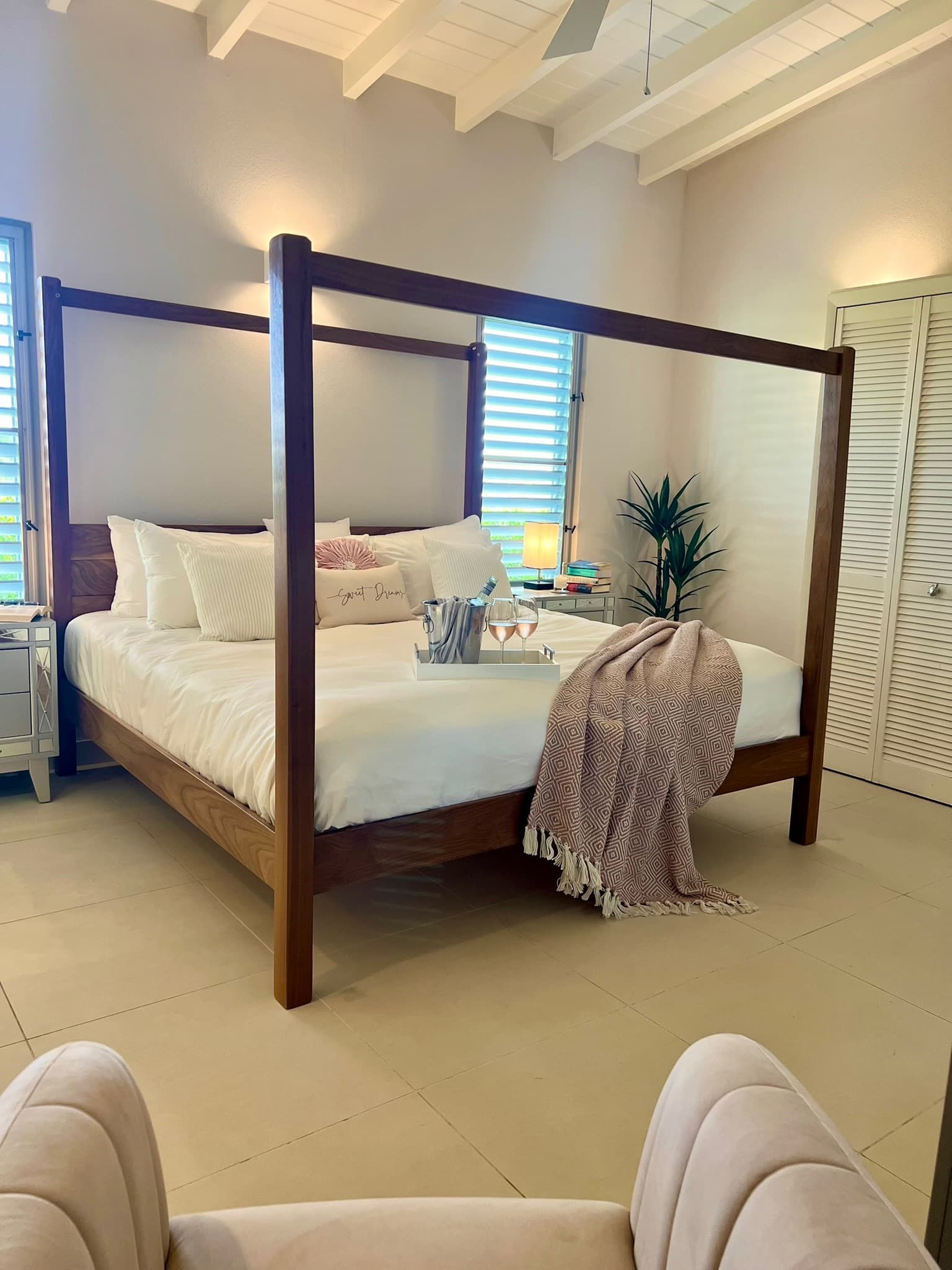 Primary Bedroom suite with Eastern King bed, AC, ceiling fan, TV, safe and ensuite Bathroom with twin basins, freestanding bathtub and walk-in rain shower