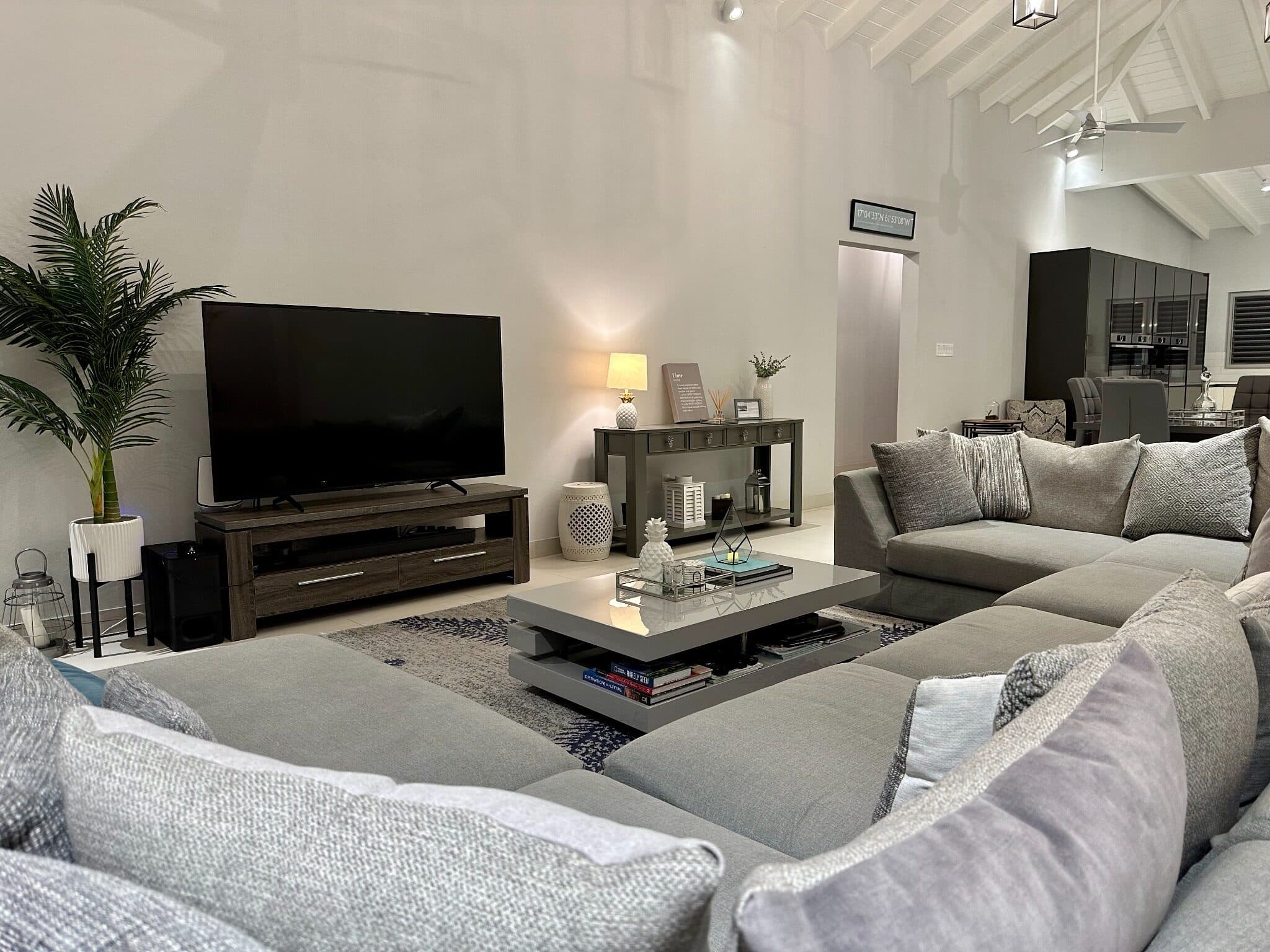 Spacious open-plan Lounge with comfortable seating and large-screen TV