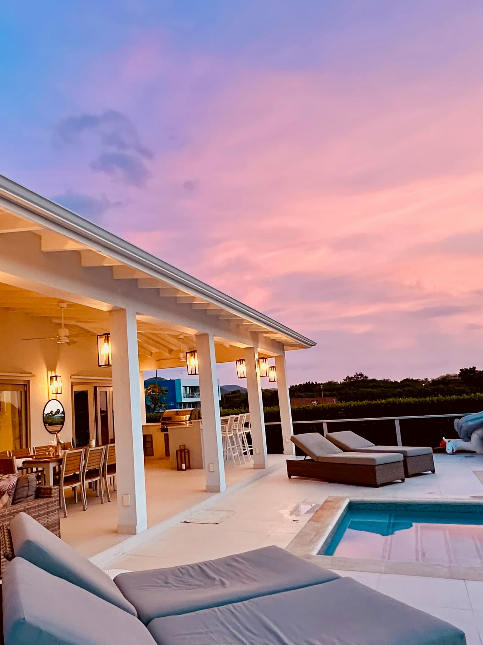Coco Palms terrace and pool beneath a pink Antiguan sunset