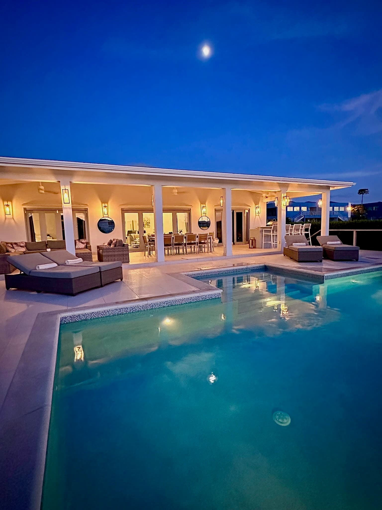 Coco Palms villa and private pool glowing at dusk